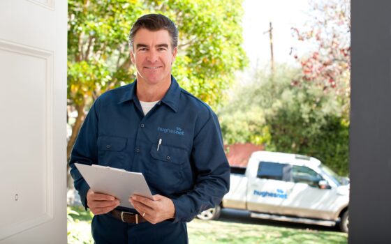 Repairman In Uniform Good looking repairman in uniform holding a clipboard with his pick up truck behind him.